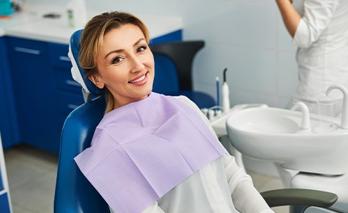 Woman smiling while sitting in treatment chair
