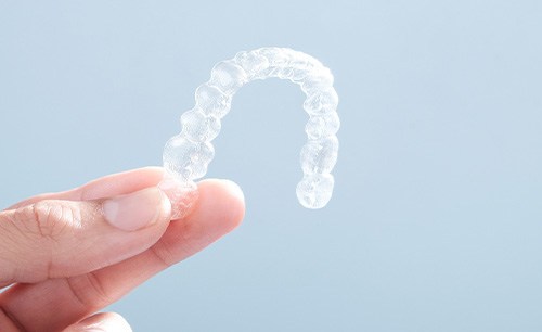Patient holding clear aligner