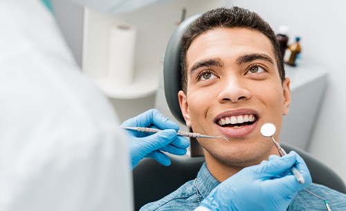 Man in denim shirt about to undergo dental exam