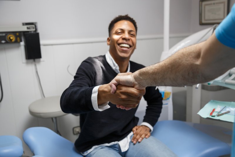 Patient smiling at their dentist after an oral cancer screening
