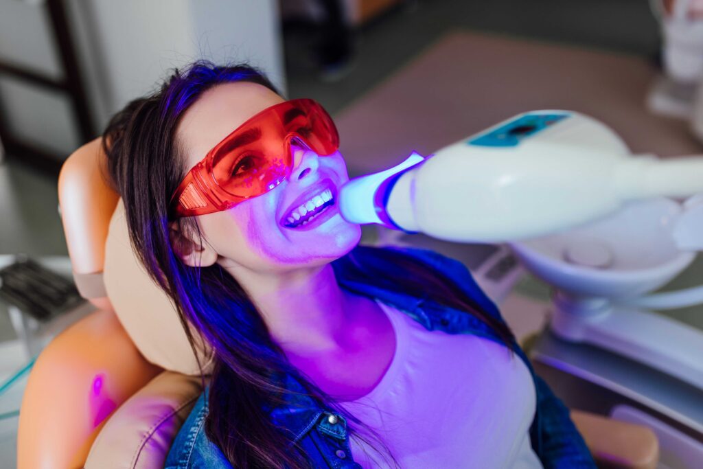 Woman getting professional teeth whitening